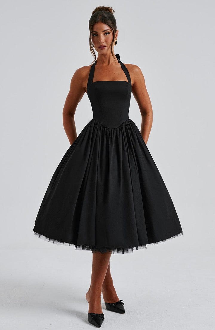 Fashionable women's black halter midi dress, a chic option for wedding attire.