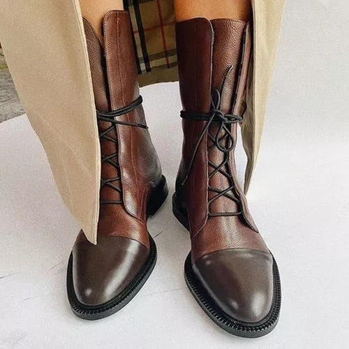 Close-up of premium leather women's comfort boots with high heel and intricate lace-up detail.