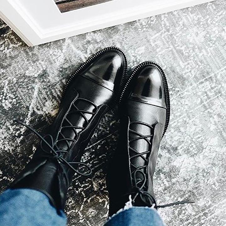 Top-down view of women's fashion boots with high heels, showing the detailed lace-up closure.