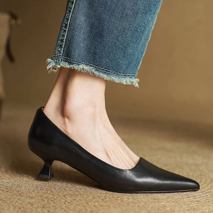 Stylish women's black leather pointed toe pumps, offering elegance & comfort for work and special events.