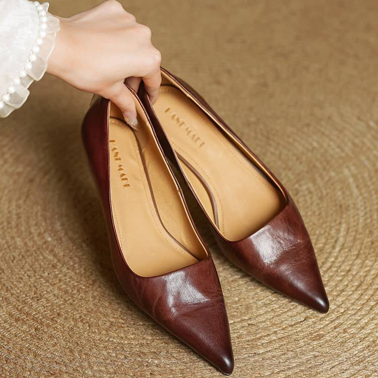 Refined black leather pointed toe pumps for women, a classic & comfortable choice for dress shoes.