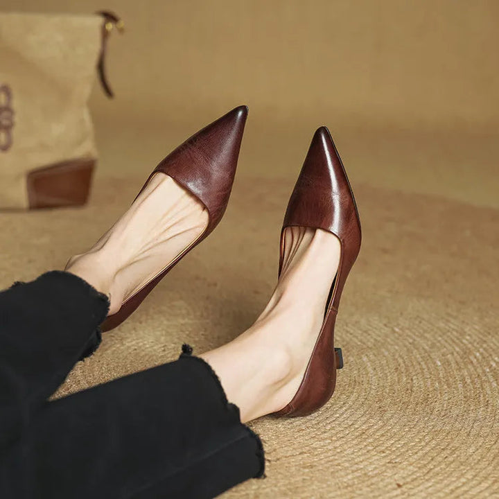 Close-up of a women's pointed toe leather pump in black, showcasing elegant design and low heel.