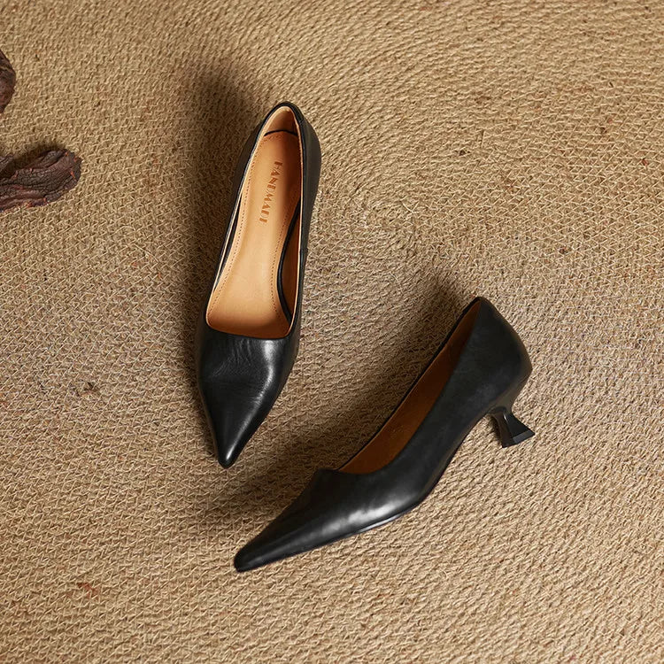 Comfortable women's refined black leather pointed toe pumps, versatile for formal, work, & dress wear.