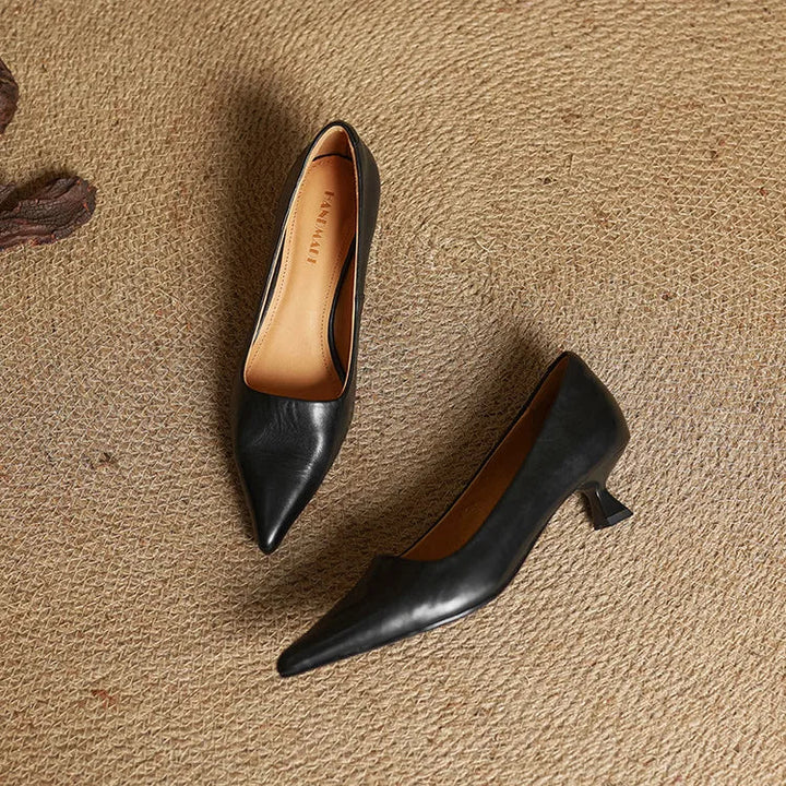 Comfortable women's refined black leather pointed toe pumps, versatile for formal, work, & dress wear.