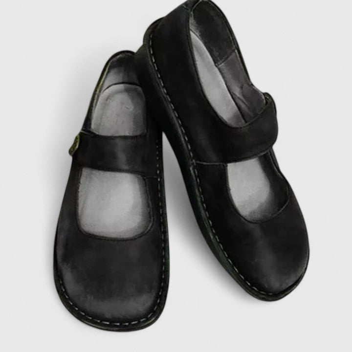 Side view of women's comfortable black Mary Jane flats, showcasing elegant design and everyday wearability