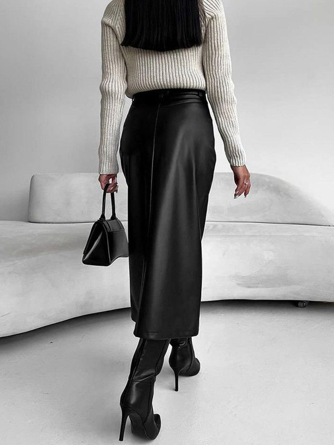 Versatile women's midi skirt in burgundy, showing a subtle slit, suitable for elegant and casual styles.