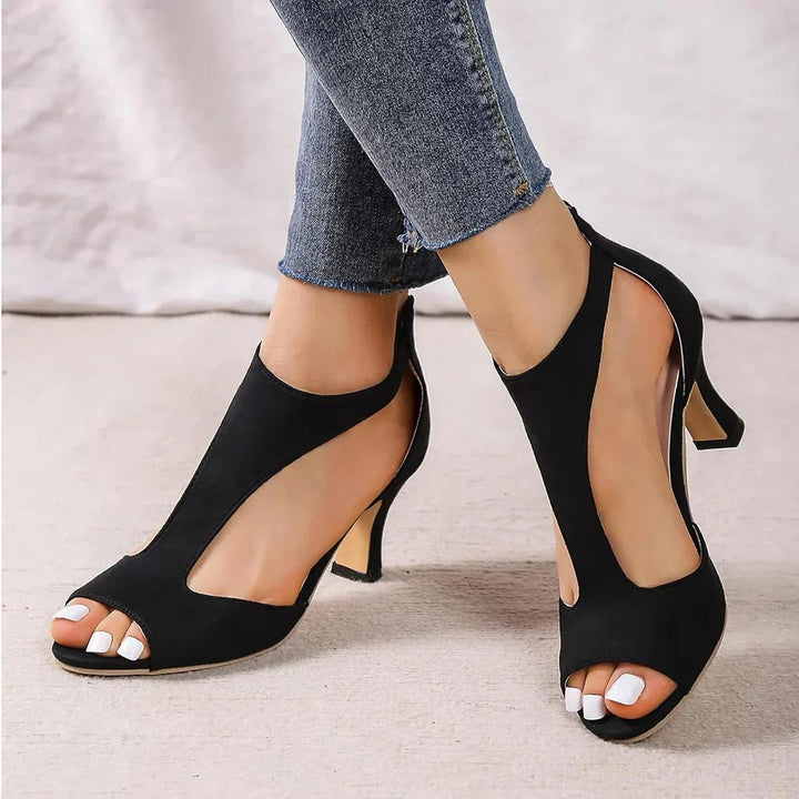 Stylish pink open toe mid heel party heels, featuring a sophisticated cutout pattern.