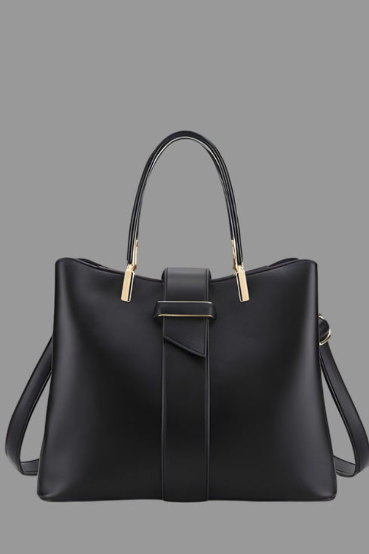 Fashionable women's structured tote bag in dark leather with dual handles and an adjustable shoulder strap for professional use