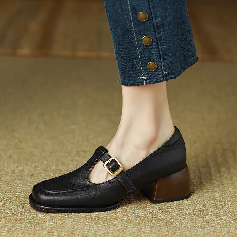 Front view of black T-strap block heel shoes, showcasing their classic and elegant appeal