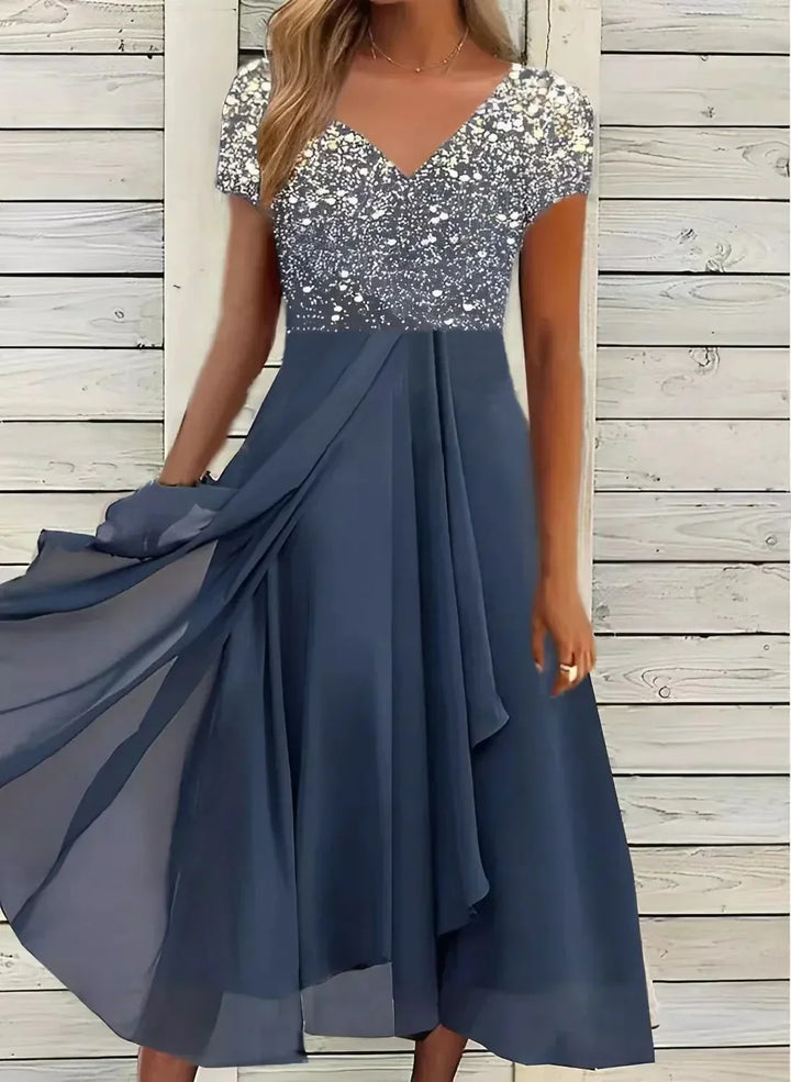 Glamorous women's party dress in a rich jewel tone fabric, showcasing versatile and fashionable apparel.