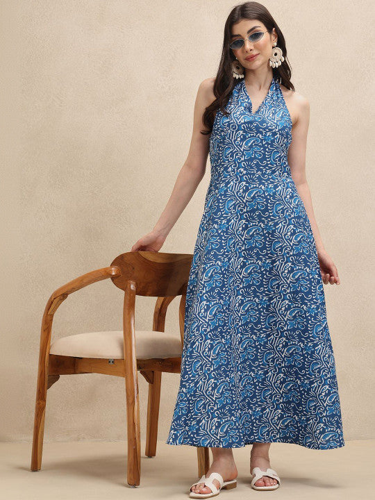 Stunning blue & white floral print halterneck maxi dress for women. Elegant flowing design perfect for summer comfort.