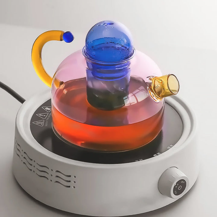 Borosilicate glass tea set displaying colorful tea, stylish addition to any kitchen.