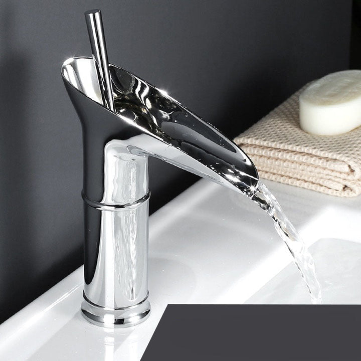 Chic matte black waterfall bathroom faucet. Modern mixer tap for elegant sink decor.