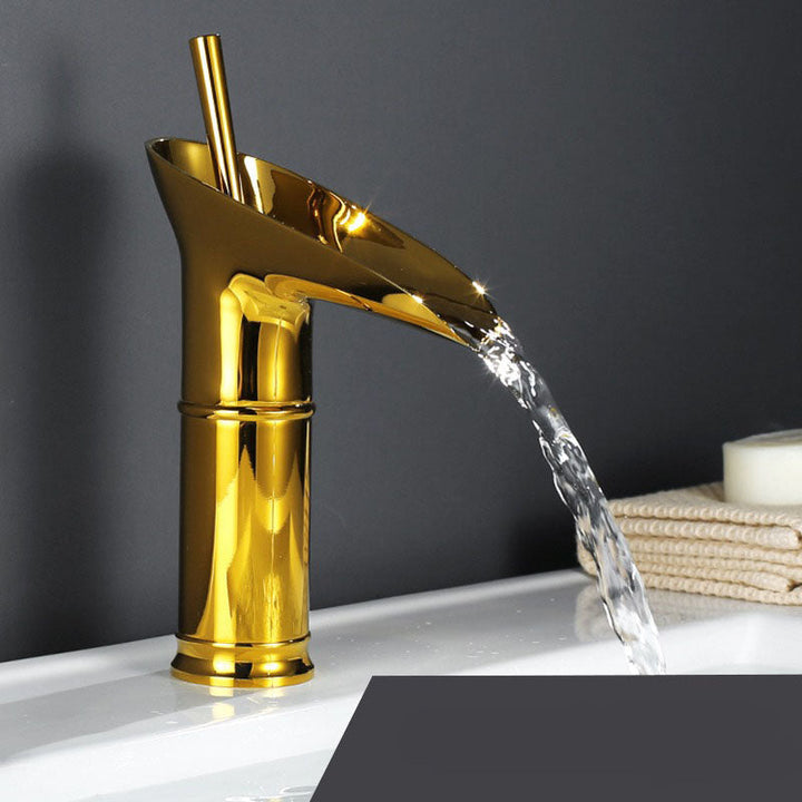 Antique gold waterfall bathroom faucet. Vintage-style mixer tap for elegant home decor.