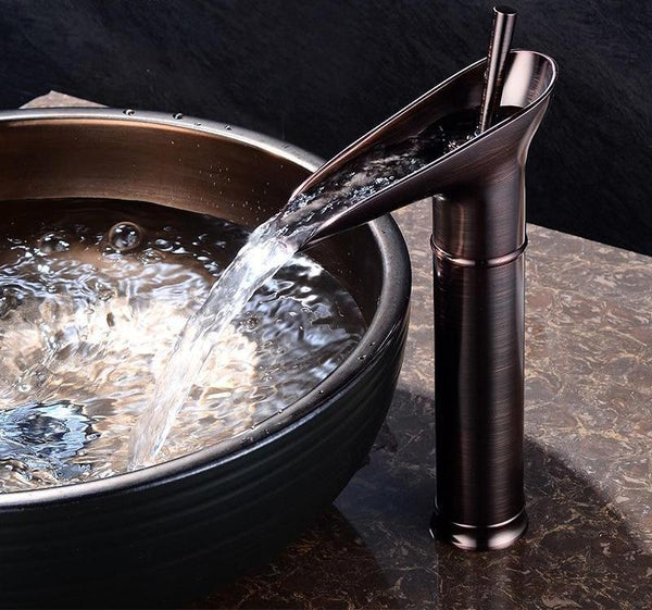 Elegant brass waterfall sink faucet. Durable mixer tap for stylish bathroom upgrade.