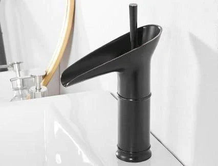 Contemporary brass waterfall tap. Elegant bathroom mixer faucet enhances modern decor.