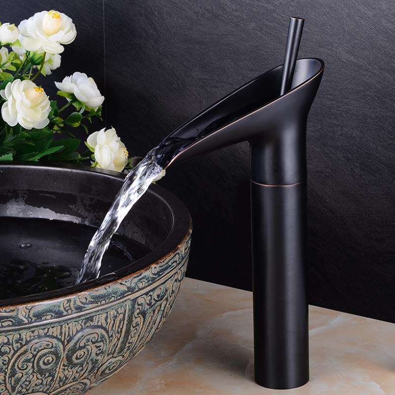 Modern gold waterfall sink faucet. Single-handle brass mixer tap for elegant bathroom.