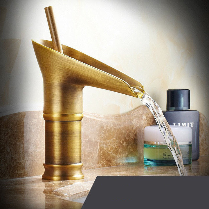Waterfall brass basin faucet. Elegant mixer tap with smooth water flow for bathroom.