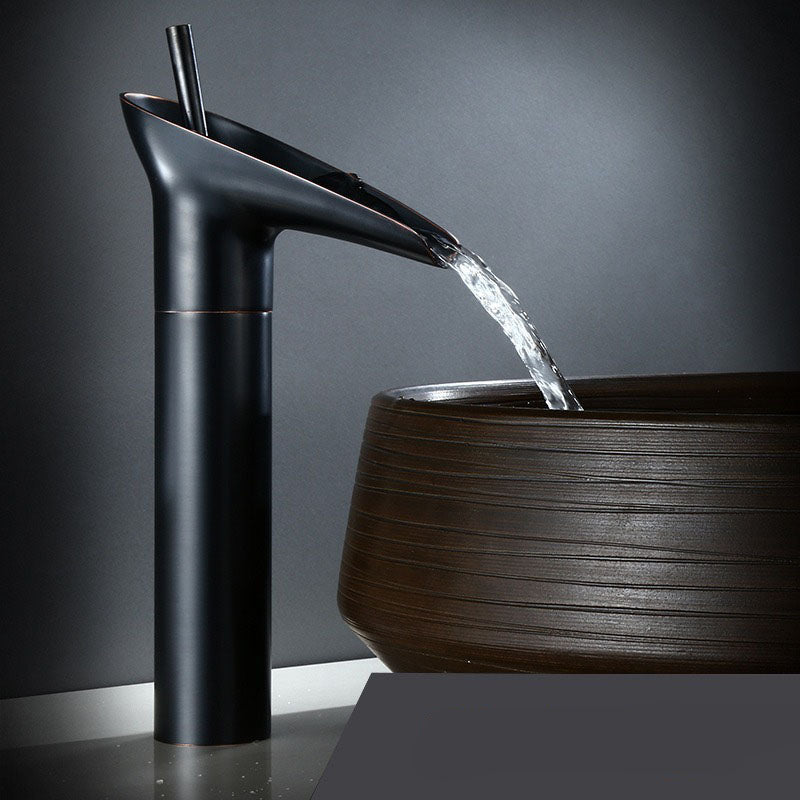 Designer waterfall bathroom faucet. Brass mixer tap creates a luxurious water cascade.
