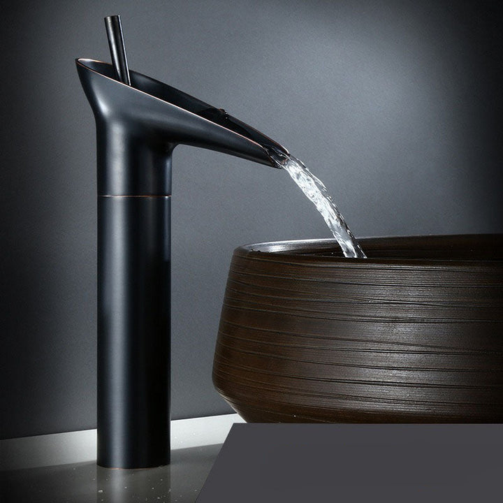 Designer waterfall bathroom faucet. Brass mixer tap creates a luxurious water cascade.