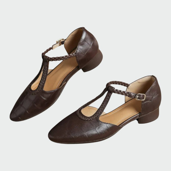 Close-up of black T-bar Mary Jane shoe showcasing pointed toe and stable block heel details
