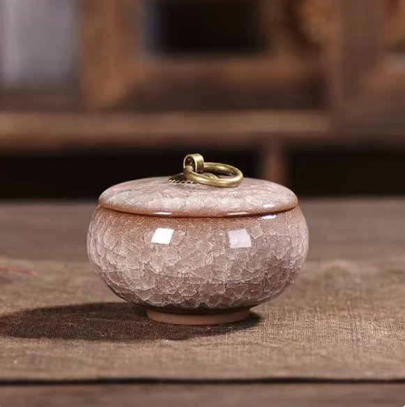 Touching ceramic pet urn, craquelé glaze, a meaningful tribute after pet loss.