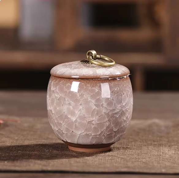 Close-up of ceramic pet urn, showing unique craquelé glaze texture for pet ashes.
