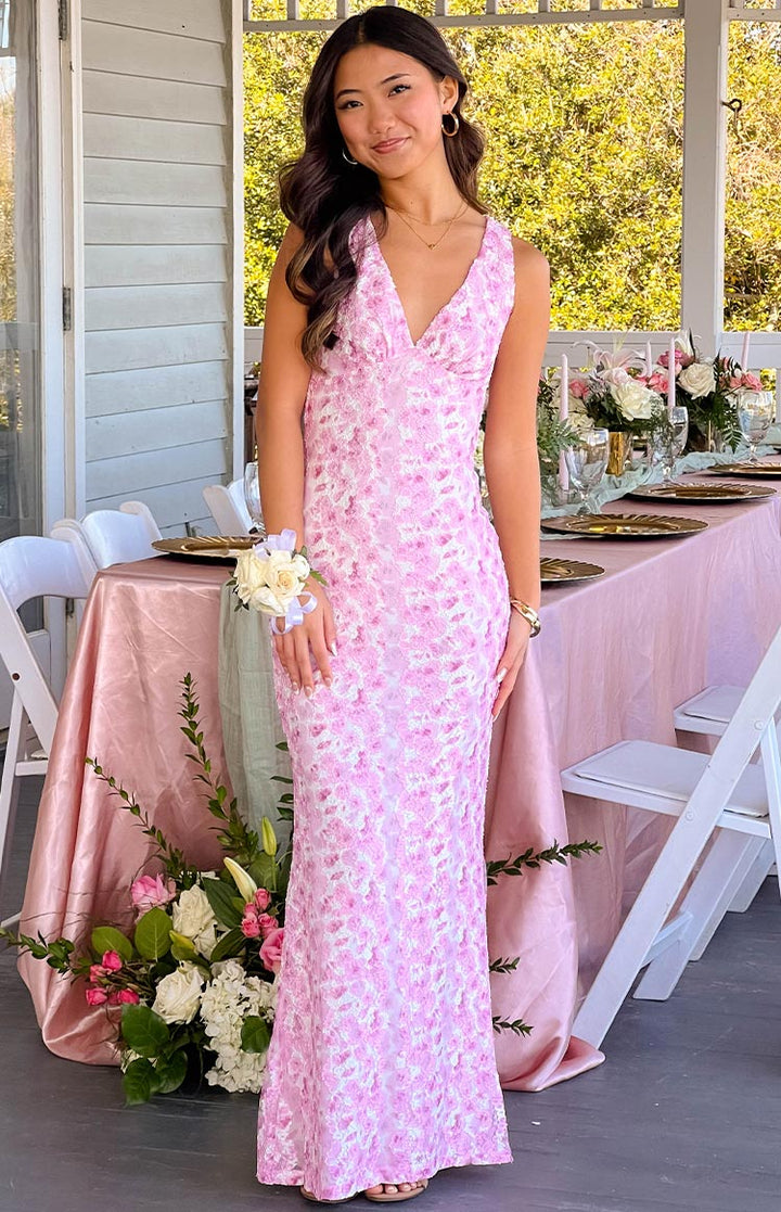 Women's elegant pink floral dress, perfect as a wedding guest outfit, with a flattering silhouette.