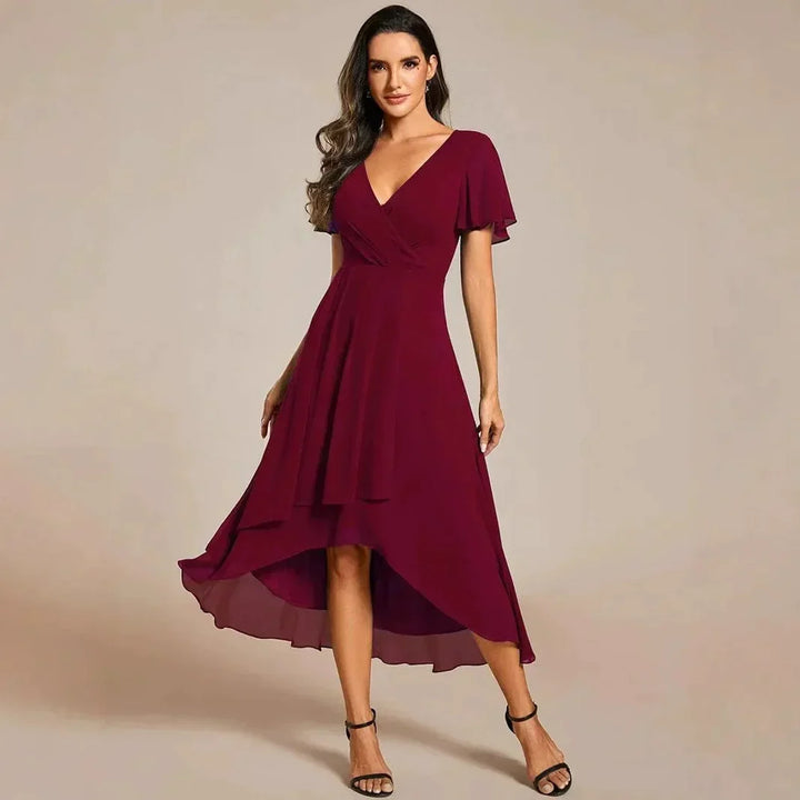Detail of the flowy skirt and A-line cut of an elegant women's V-neck maxi dress.