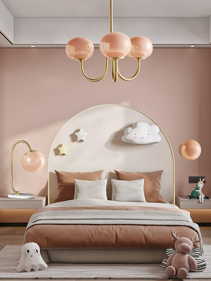 Modern brass pendant, clear glass spheres, bright ambient.