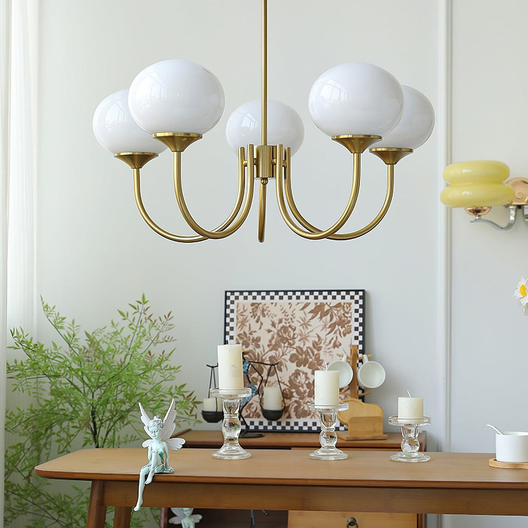 Modern living room brass pendant light, glass spheres.