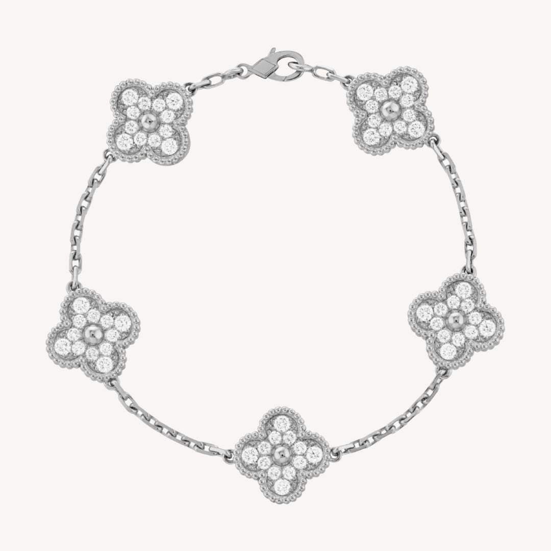 Elegant gold women's bracelet, showcasing intricate clover charm details.