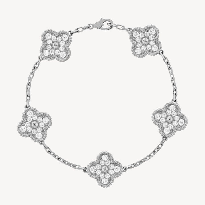 Elegant gold women's bracelet, showcasing intricate clover charm details.