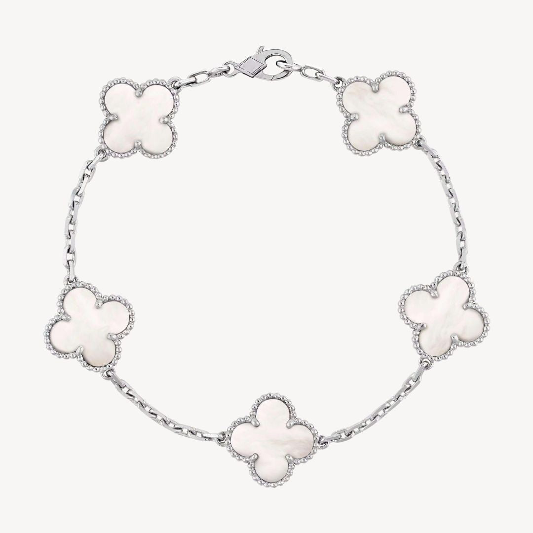 Women's elegant silver charm bracelet, featuring lucky clover designs.