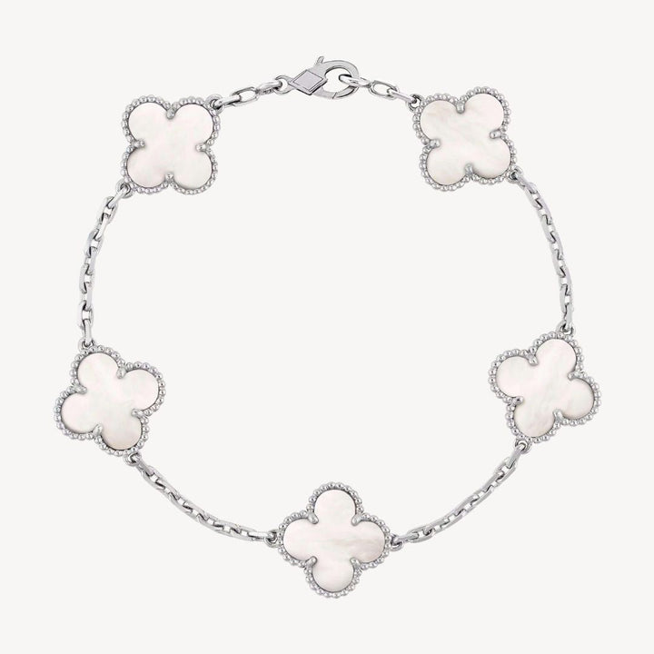 Women's elegant silver charm bracelet, featuring lucky clover designs.