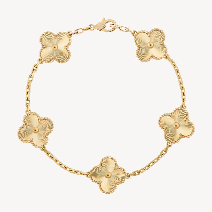 Beautiful gold charm bracelet with multiple clover designs, an ideal gift for her.