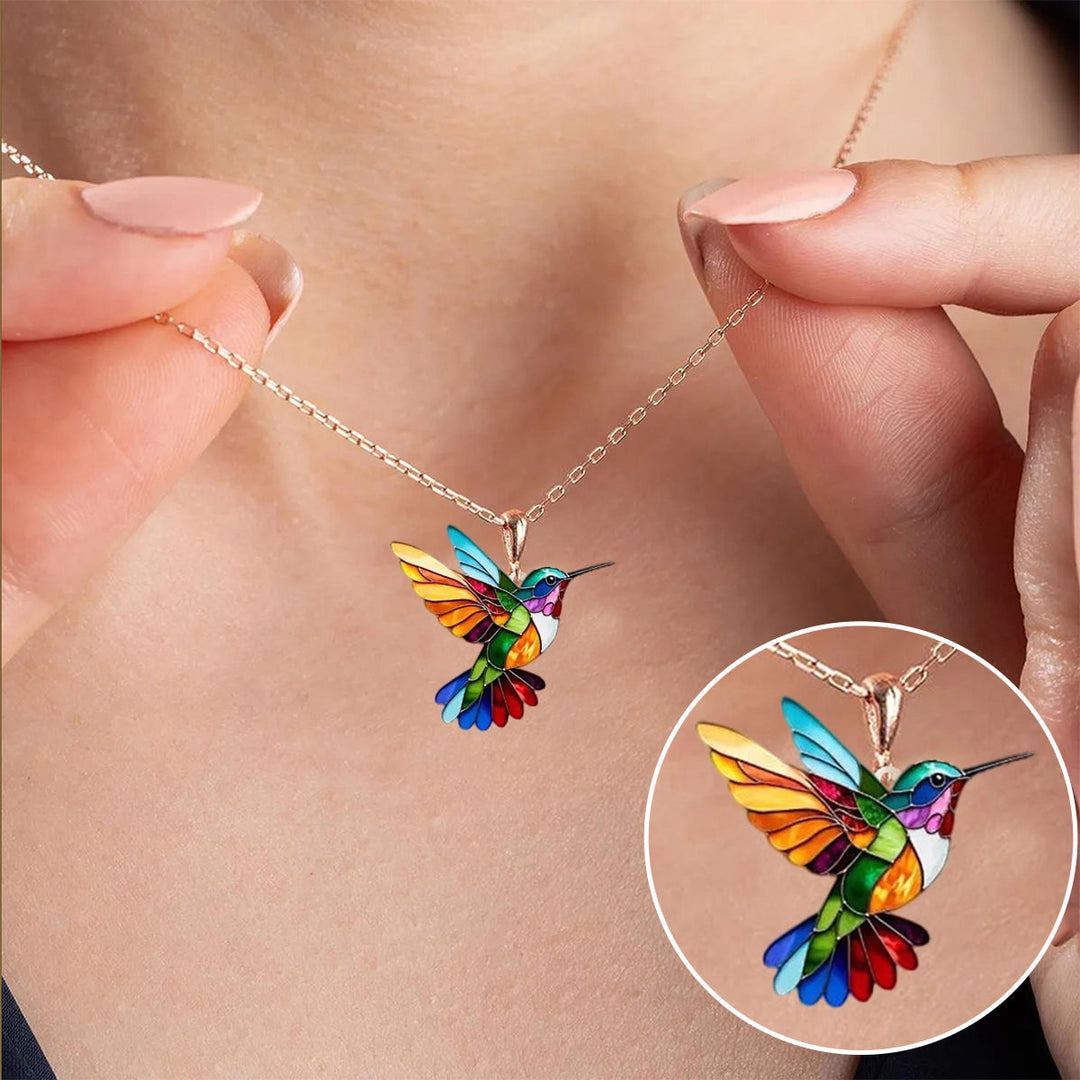 Elegant golden hummingbird necklace for women. Dainty charm, modern style accessory.