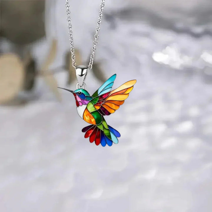 Women's elegant hummingbird charm necklace, a stylish golden accessory.