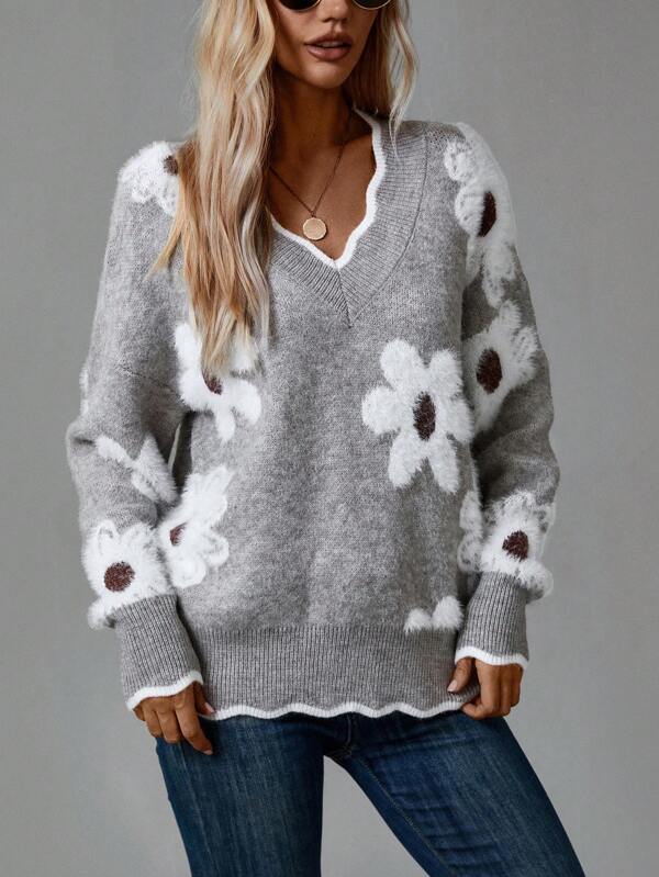 Stylish women's grey V-neck sweater featuring a delicate floral knit pattern and long sleeves.