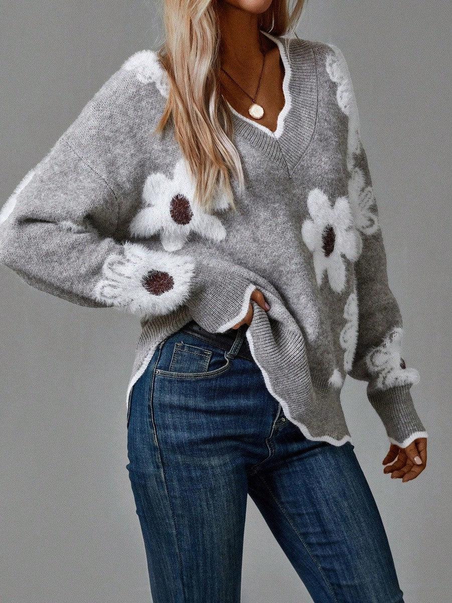 Grey women's sweater with V-neck and floral knit design, offering both elegance and cozy wear.
