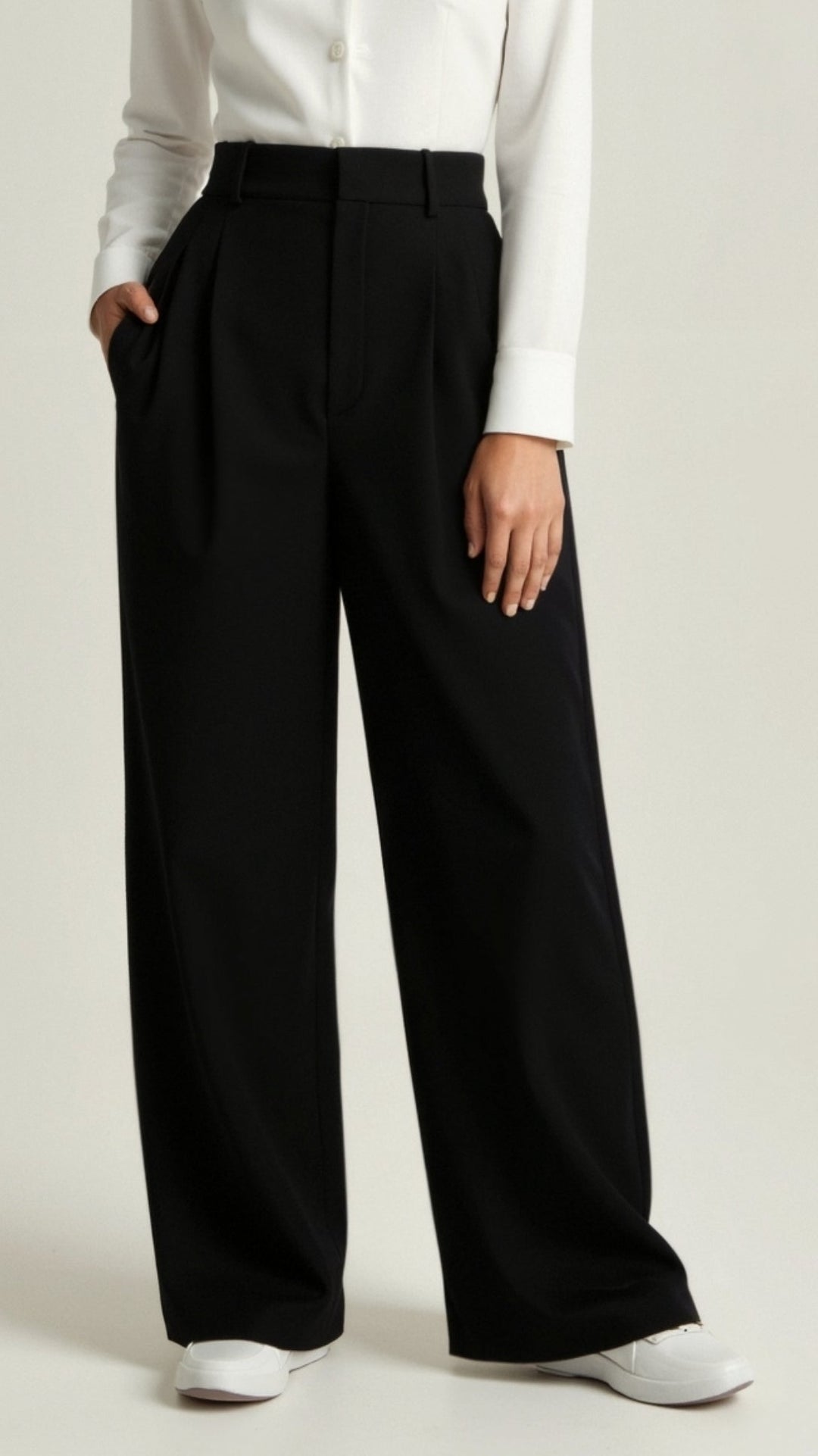 Detailed shot of the high waist and wide leg on women's palazzo trousers, emphasizing the cut.