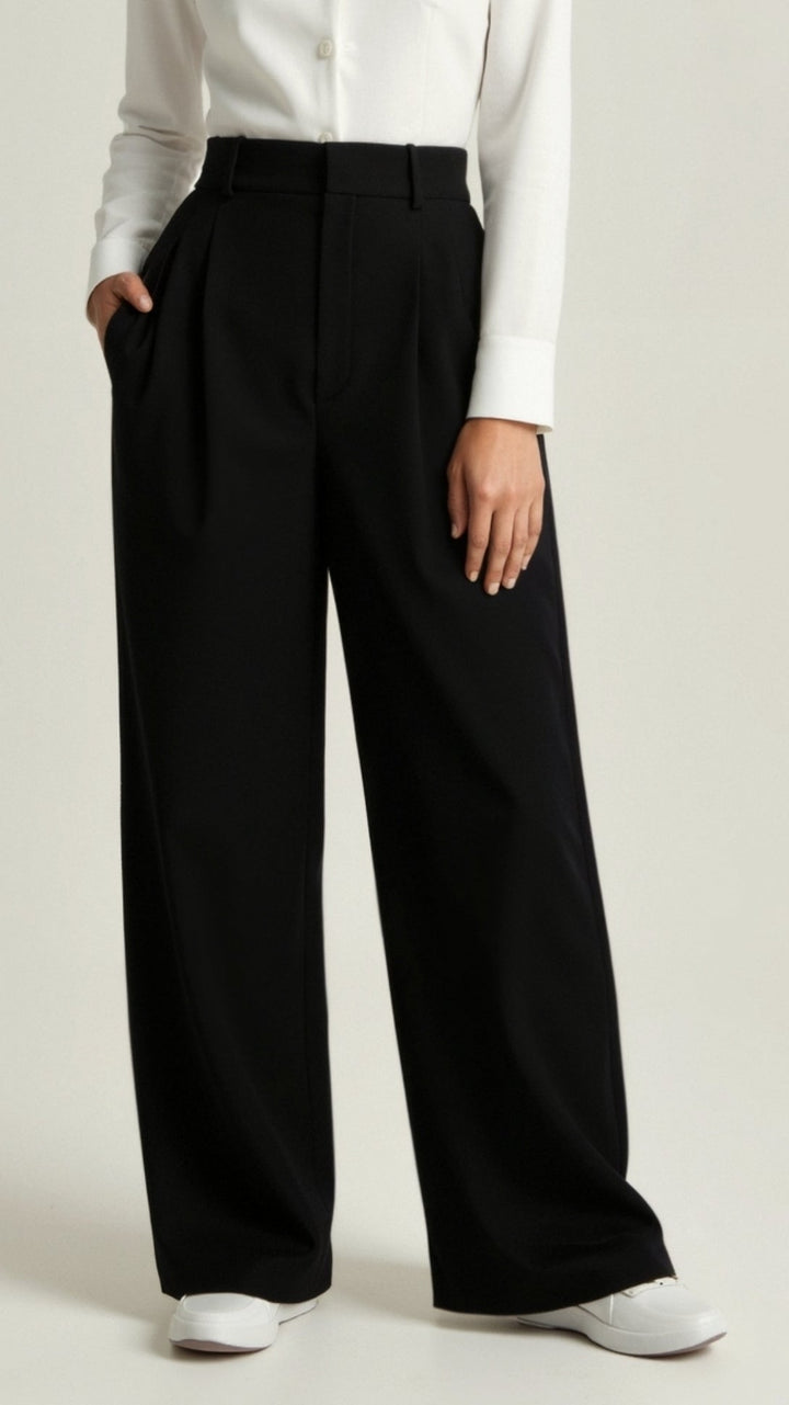 Detailed shot of the high waist and wide leg on women's palazzo trousers, emphasizing the cut.