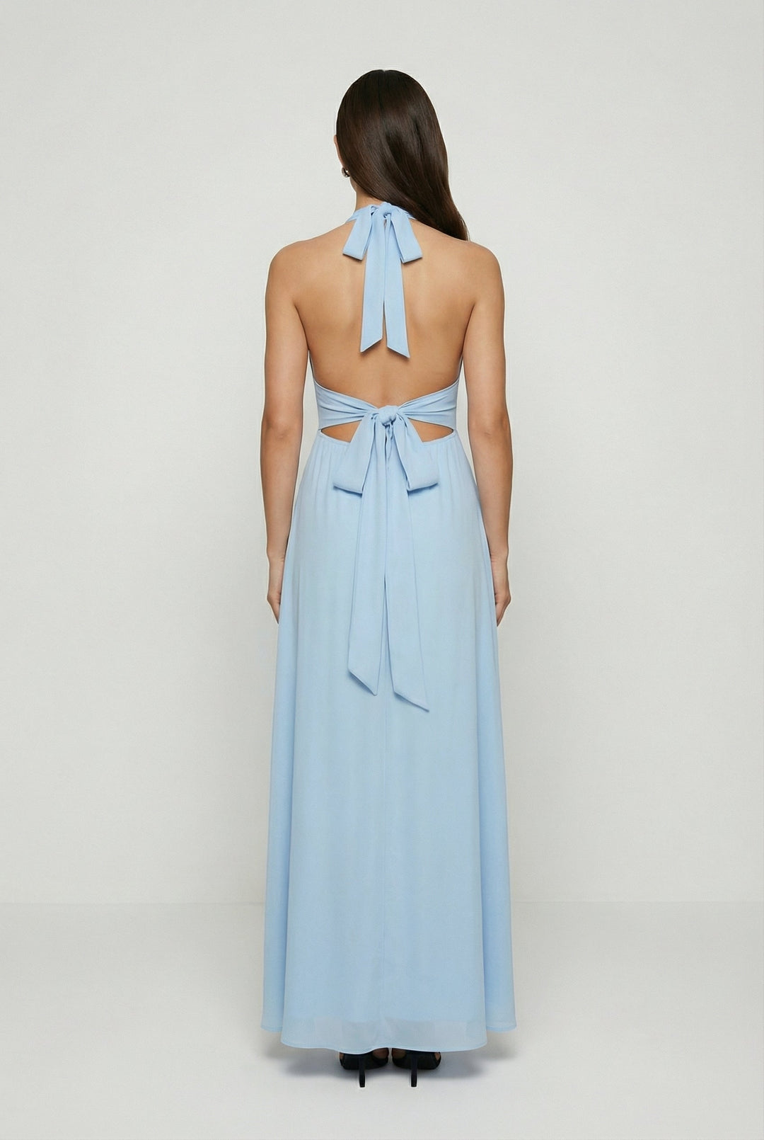 Chic women's flowy maxi dress featuring a stylish halter neck, backless design, and a flattering high slit.