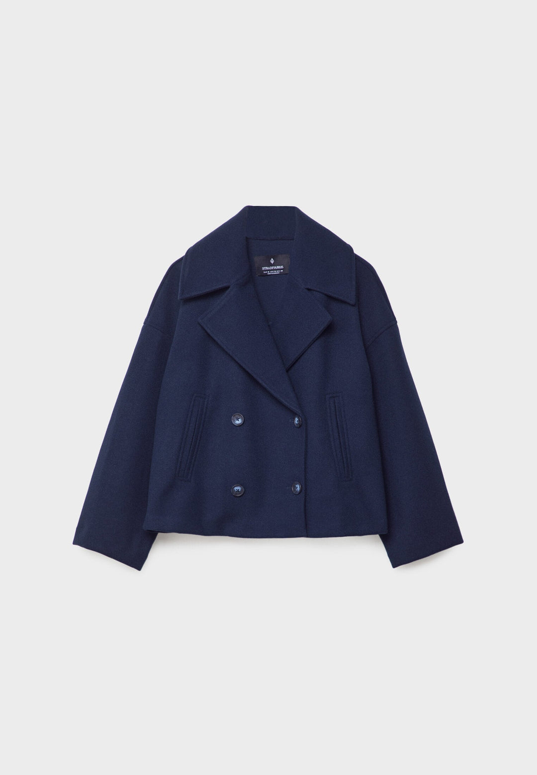 Close-up of elegant double-breasted lapels & buttons on a women's lightweight summer jacket.