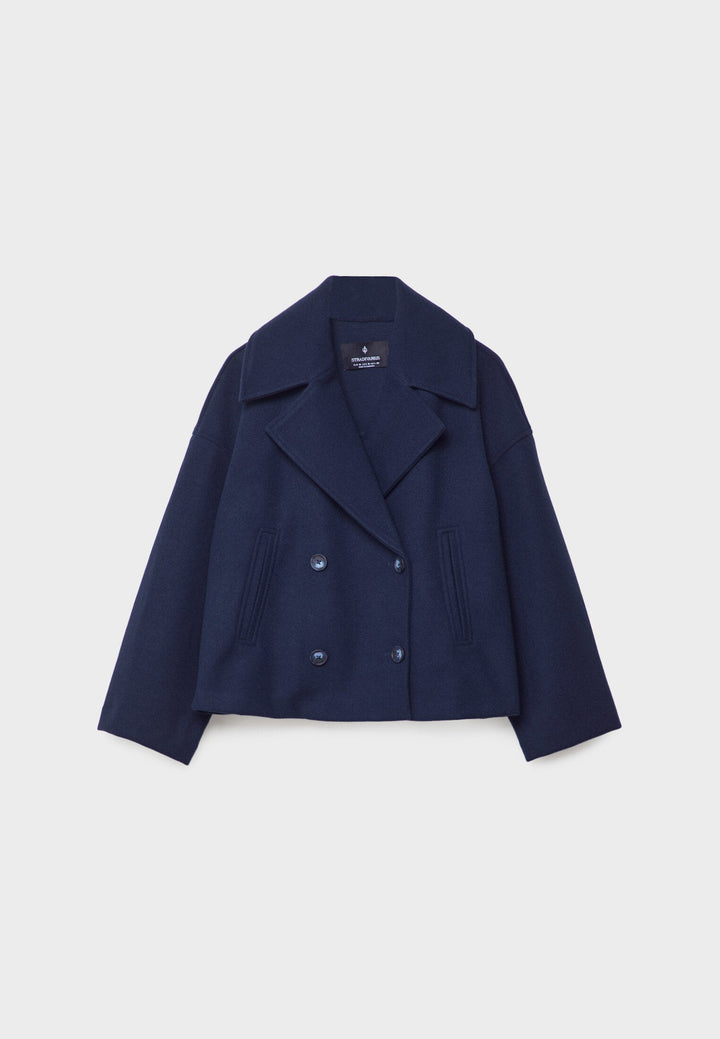 Close-up of elegant double-breasted lapels & buttons on a women's lightweight summer jacket.