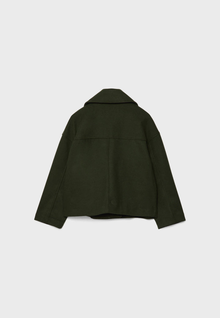 Woman in elegant lightweight double-breasted summer jacket. Flowy outerwear for movement & style.