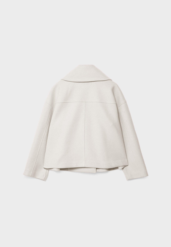 Modern elegant lightweight short jacket for women. Double-breasted summer outerwear for fashion-forward style.