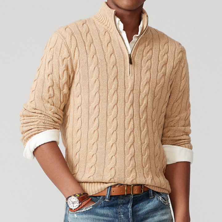 Close-up of the intricate cable knit texture on a cozy men's quarter-zip pullover sweater.