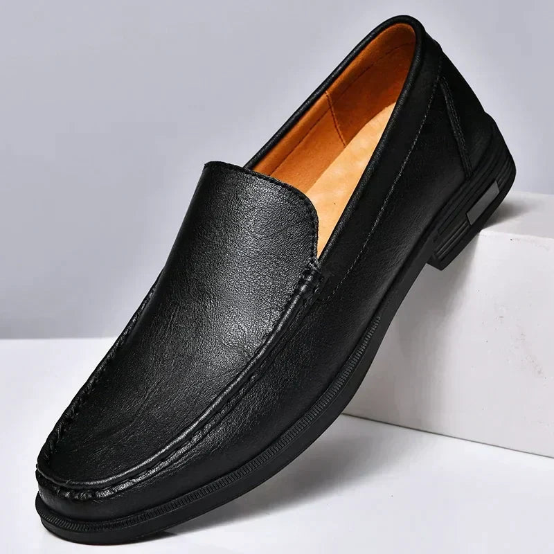 Black elegant men's dress loafers, offering sophisticated slip-on comfort for formal occasions & stylish looks.