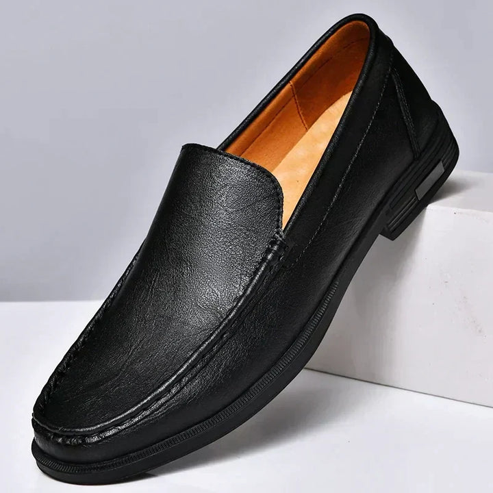 Black elegant men's dress loafers, offering sophisticated slip-on comfort for formal occasions & stylish looks.